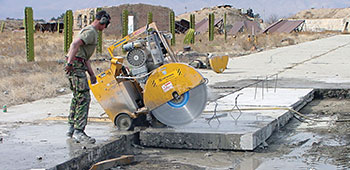 Special concrete saws were used by the engineers to cut the broken slabs into sections before removal.