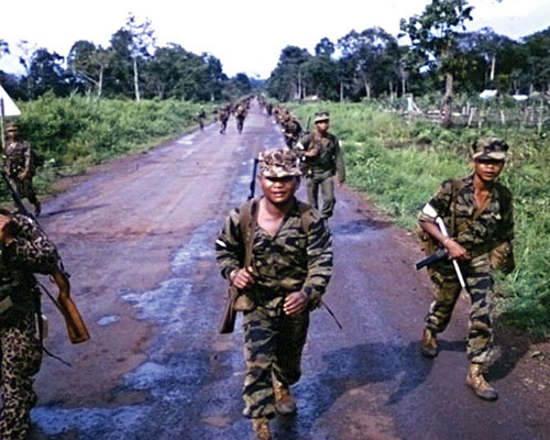 The rebel Montagnard platoon that seized the Ban Me Thuot radio station on their road march to Buon M’Bre. The white armbands on the right arm identify them as FULRO.