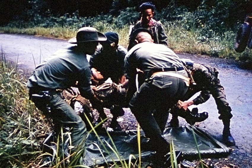 Captain Vernon Gillespie and Sergeant First Class Ernie Tabata at the jeep accident scene.