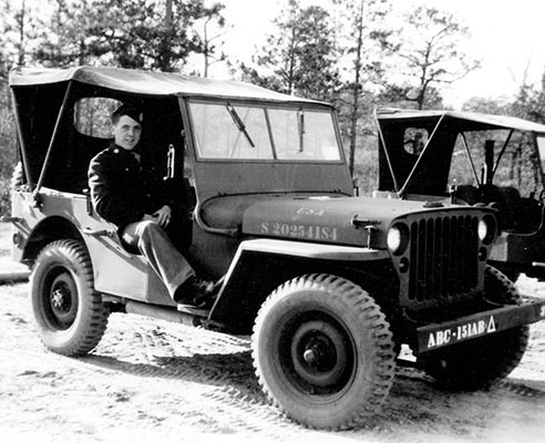Pvt. William Rasbold sits in a jeep of the 151st Reconnaissance Platoon at Camp Mackall, 1944. Of interest is the unit designation on the front bumper, Airborne Command 151st Airborne Tank (ABC-151ABΔ).
