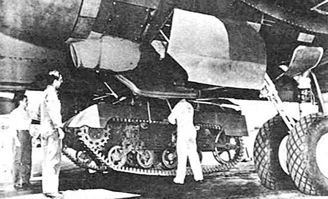 An M22 belly-slung under a C-54 cargo aircraft. This method of transport required that the turret be removed and placed inside the aircraft while in transit.