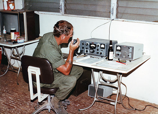 Master Sergeant Rodney Dutton, ODA-7 team sergeant, uses the AN/FRC-93 shortwave radio to make a MARS call to his family in Panama at night.