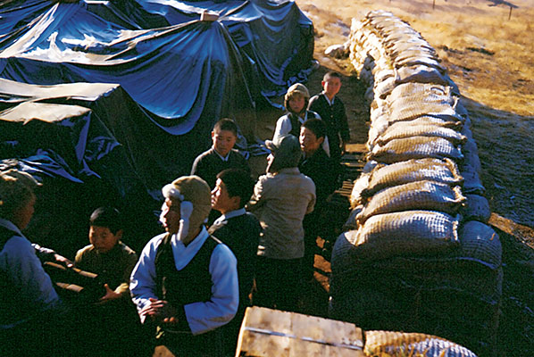 Some of the partisans were accompanied by their families when they occupied the islands. Young children are present in this photo of a detail loading rice bags on Kangwha-do.