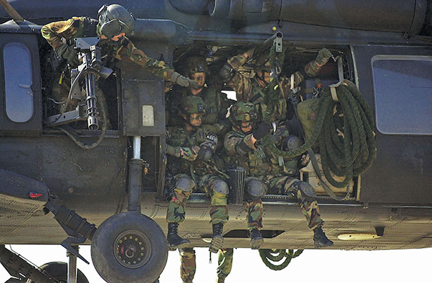 Army Rangers on board a UH-60A Black Hawk ready to “fast-rope” onto an objective. A Company, 245th flew the UH-60A from 1987 until 1994.