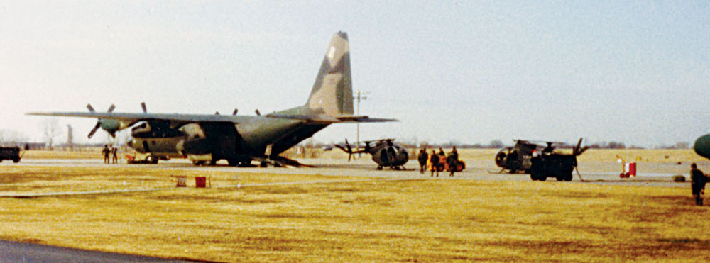 OH-6s are loaded aboard a U.S. Air Force C-130 Hercules at the Air National Guard facility at the Tulsa airport.