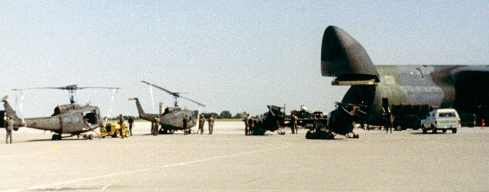 Preparing and loading UH-1H Hueys and OH-6s aboard a U.S. Air Force C-5A Galaxy