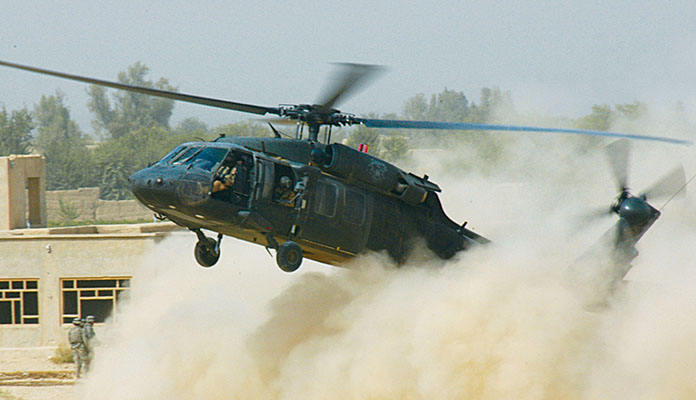 A UH-60 Black Hawk medical evacuation helicopter created a dust cloud landing near Sperwan Ghar.