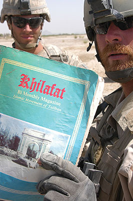 Special Forces soldiers with a Taliban newsletter.