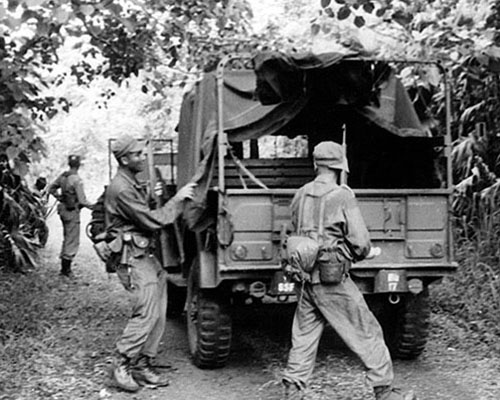 The Salvadoran Ranger students search the ambushed convoy for equipment and documents.