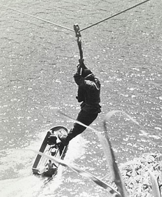 A Salvadoran Ranger student traverses the Chagres River on a rope slide before dropping into the water near the far bank.