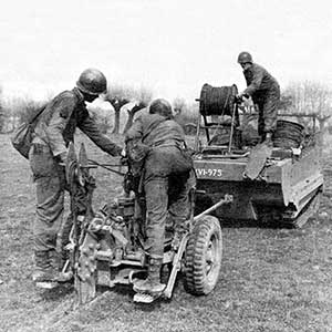 “Cable Dogs” of the 112th Signal Battalion  burying communications cable to support the  First Airborne Task Force (ATF) in Operation  VARSITY, March 1945.  The 112th soldiers  parachuted across the Rhine to provide  communications support. The 112th later  established the 1st ATF communications  network during the link-up with the Russian  Army on the Baltic.