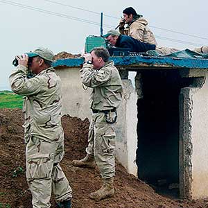 Calling Close Air Support in northern Iraq during Operation IRAQI FREEDOM. Members of the 10th Special Forces Group supported the Kurds in OIF. ARSOF units often have Air Force Tactical Air Combat Controllers attached, who guide the aircraft carrying aerial delivered munitions using the AN-PRC 117 Multiband Tactical Radio.