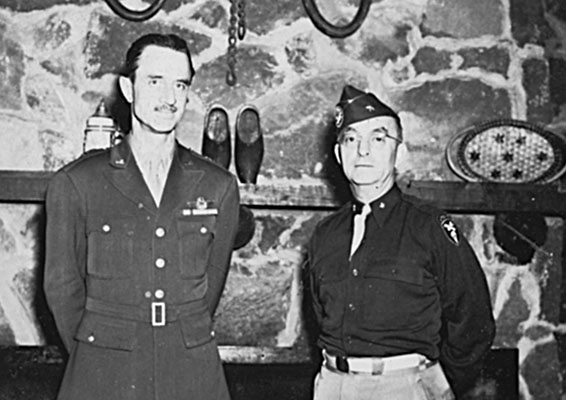 BG Frederick W. Evans, CG, I TCC and BG Leo Donovan, CG Airborne Command in front of the fireplace in the VIP briefing cabin at Camp Mackall. This same cabin today houses Camp Mackall’s Range Control office.