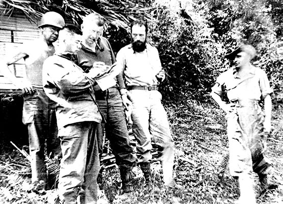 CPT Vince Curl, with beard, briefs the Marauder’s commanding officer, BG Franklin D. Merrill (with pipe) on 15 March at Naubum.