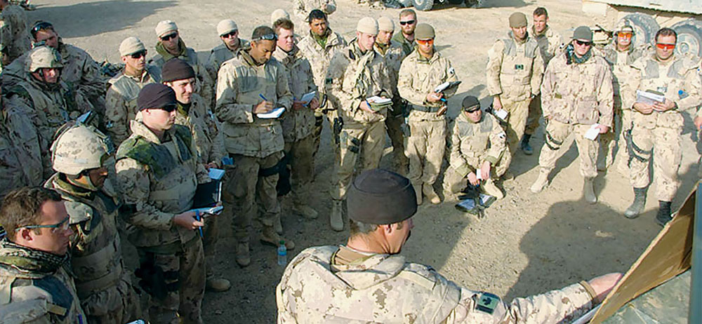 Canadian troops of TF-Kandahar receiving an operations briefing during Operation BAAZ TSUKA. TF-Kandahar executed the supporting attack that seized the town of Howz-E-Madad.