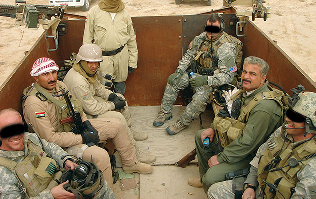 Iraqi Colonel Abbas, the current commander of the Hilla SWAT (right side center), often rode in the bed of the ODA 563 “War Pig,” an armored 5-ton  truck with three M-240 machineguns.