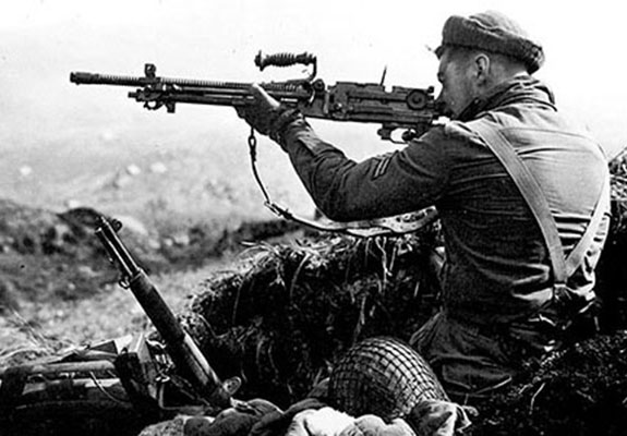 A Forceman in an abandoned Japanese defensive position on Kiska aims a Type 96 light machinegun. The hurried Japanese evacuation meant a wealth of souvenirs for the occupying troops.