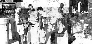 5. Technical Sergeant Steven J. Wargo checks drop containers at Nazira, India, (late 1943). These were later replaced by more economical and practical versions.