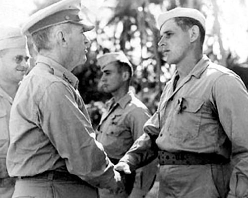 LTG Walter Krueger congratulates SGT Gilbert Cox after awarding him the Silver Star. PFC Galen C. Kittleson, also a Silver Star recipient is in the background. Leyte, Philippines, 1944.