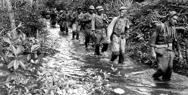 Alamo Scout training was arduous and intensive, concentrating on reconnaissance techniques and honing the men’s ability to move through the jungle. Here trainees at the ASTC at Kalo Kalo conduct a forced march on Fergusson Island, New Guinea, February 1944.