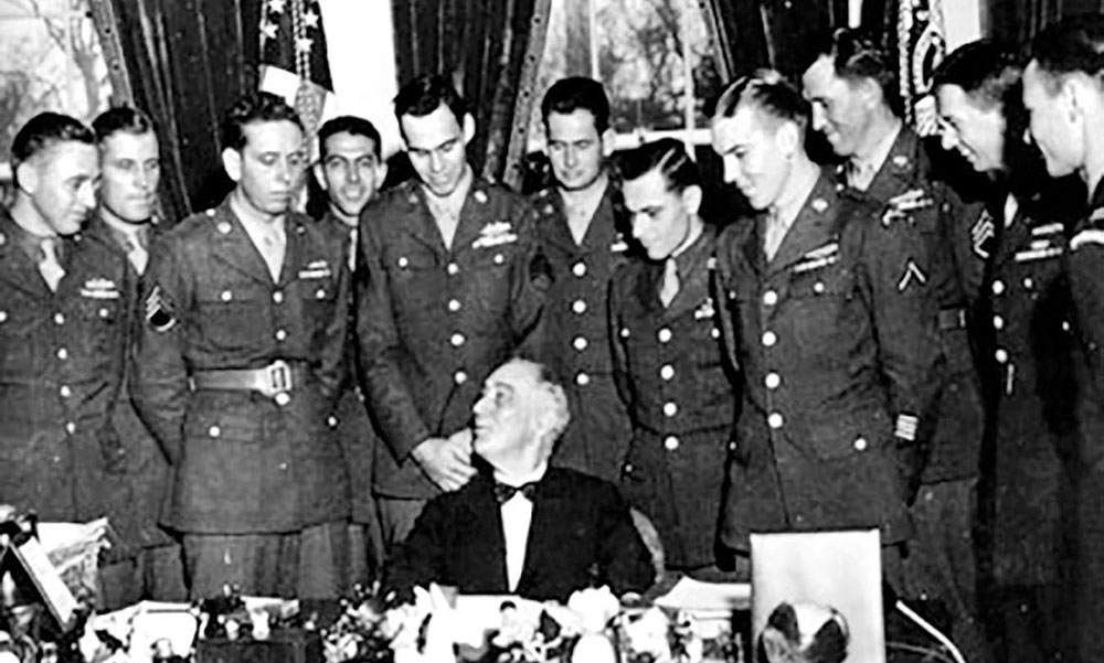 Following the successful Cabanatuan Prison Rescue, a select group of Rangers and Alamo Scouts were brought back to the United States to participate in a War Bond drive. Here the men meet with President Franklin Delano Roosevelt in the White House. Alamo Scouts SGT Harold Hard, Rounsaville Team and SGT Gilbert Cox, Nellist Team  were part of the publicity campaign surrounding the successful rescue, March 1945