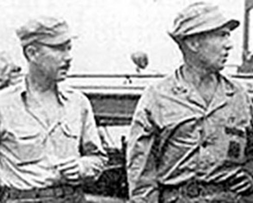 LTC Frederick Bradshaw with LTC Sylvester Smith of Sixth Army G-2 on the boat dock at the Alamo Scout Training Center (ASTC), Fergusson Island, New Guinea. Bradshaw, a lawyer from Mississippi, formed the ASTC and served as the first director.