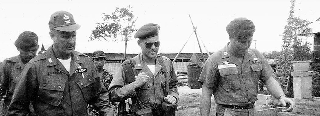 COL Blackburn (left) visits a MACV-SOG field location in Vietnam. As the commander of MACV-SOG, Blackburn restarted the cross-border operations that had been  terminated with the failure of the LEAPING LENA program.