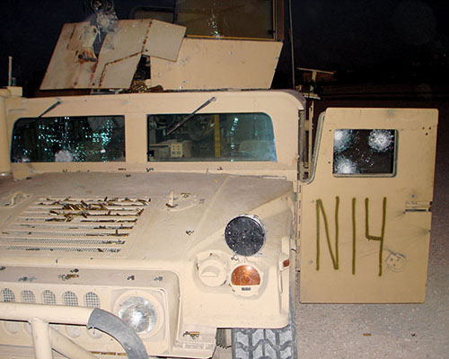 Raptor mini-gun truck being overhauled at Camp David. Ammunition brass is still visible on the hood.