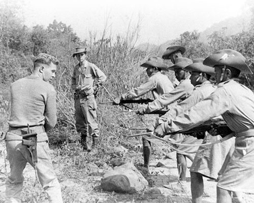 1LT Daniel Mudrinich instructs Kachin recruits in the use of the .30 M1 carbine. Notice the thick jungle scrub which is common in north Burma.