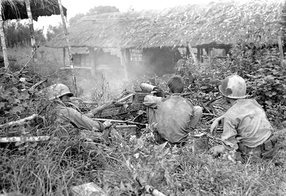 Soldiers from Merrill’s Marauders use a M1917A1 water-cooled machinegun to fire on Japanese positions about 100 yards away in Myitkyina.