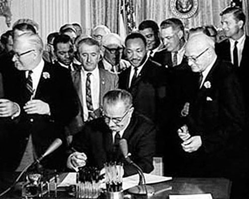 As Dr. Martin Luther King watches, PresidentJohnson signs the Civil Rights Act of 1964 on 2 July. The act, whose passage was cemented by the murders of Schwerner, Goldman, and Cheney and King’s speeches, outlawed racial segregation in schools, public, places, and employment.
