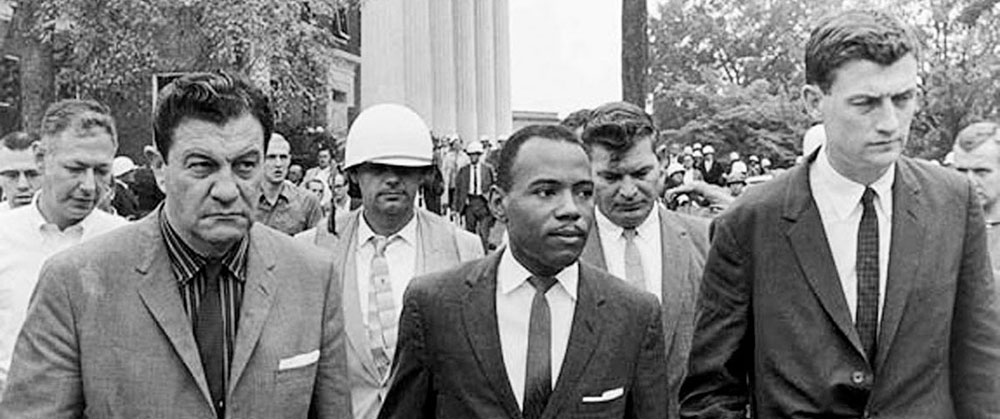 James H. Meredith, flanked by U.S. Marshals, was the first African-American student to attend the University of Mississippi. Supported by Mississippi’s governor, Ross R. Barnett, the school’s refusal to allow Meredith to attend forced President John F. Kennedy to send federal agents and troops to ensure his safety and to quell white mobs.