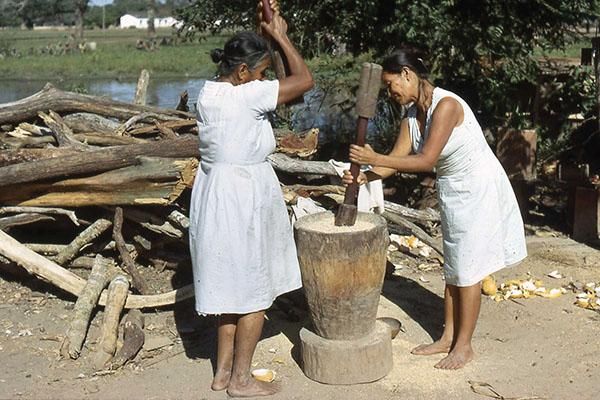 La Esperanza villagers grinding corn.