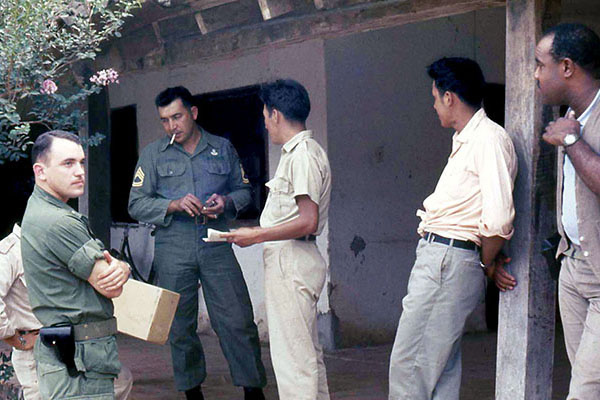 1LT Harvey W. Wallender (left) replaced CPT Margarito Cruz in October 1967. Here SFC Daniel Chapa and he talk with the “agents.”