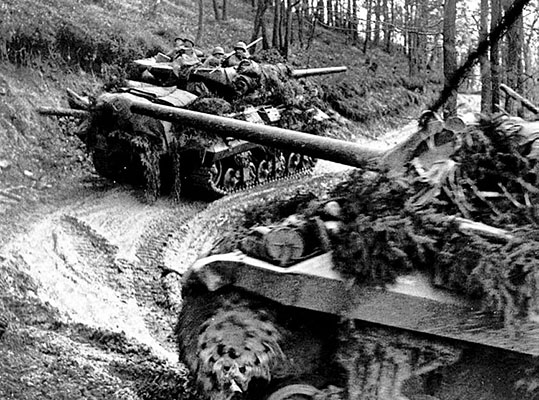 M-10 Tank Destroyers moving on a narrow trail through the Hürtgen Forest.
