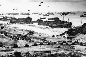 Landing Ship Tank (LST) offloading vehicles, troops and cargo on Omaha Beach a few days after the invasion.