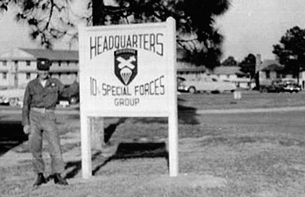 10th Special Forces Group soldier stands by the unit sign on Smoke Bomb Hill, Fort Bragg, NC, 1953.