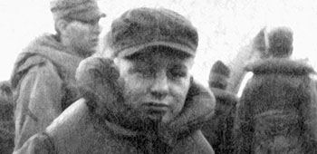 Private Vaclav Hradecky bundled up in his life jacket during a lifeboat drill on the troopship carrying him to New York.
