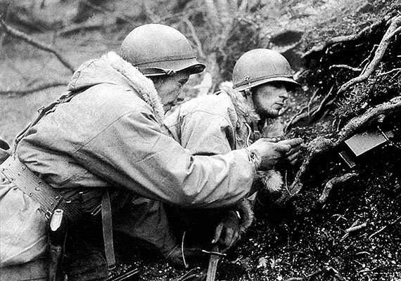 Force Headquarters scouts, Private D. M. M. Hill and Private Francis B. Wright disarm a German mine.