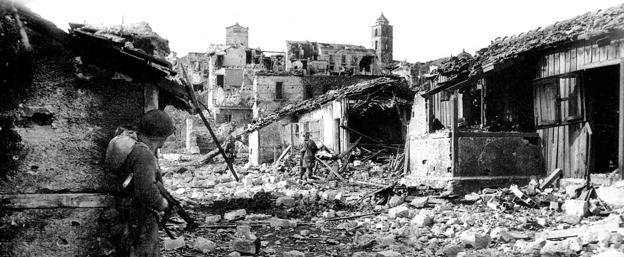 A Force combat patrol clears a ruined village near Radicosa.
