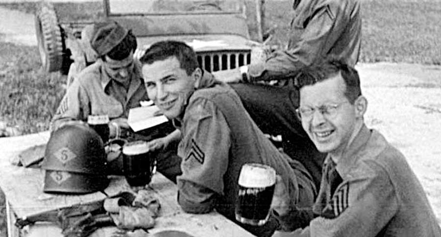 Rangers from Headquarters Company enjoy a beer during occupation duty in Germany. They have the older Ranger insignia on their shoulder and the Ranger diamonds with a “5” inside painted on their helmets.