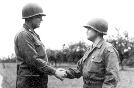 LTC James E. Rudder congratulates Chaplain Joseph Lacy after presenting him with the Distinguished Service Cross for his actions on D-Day.