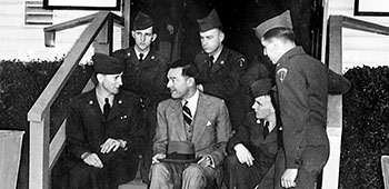 Senator Henry Cabot Lodge, Jr. chats with Private Thomas Von Doza and several of his Lodge Act buddies about their impressions of the U.S. Army and the United States outside their barracks at Camp Kilmer, NJ on 14 October 1951.