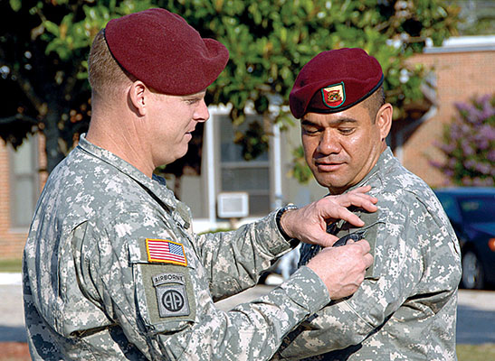 COL Duane A. Gamble places the new 528th Sustainment Brigade SSI on the uniform of CSM Charles M. Tobin