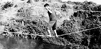 An ARVN Ranger crosses an improvised two-rope bridge at Song Mao.