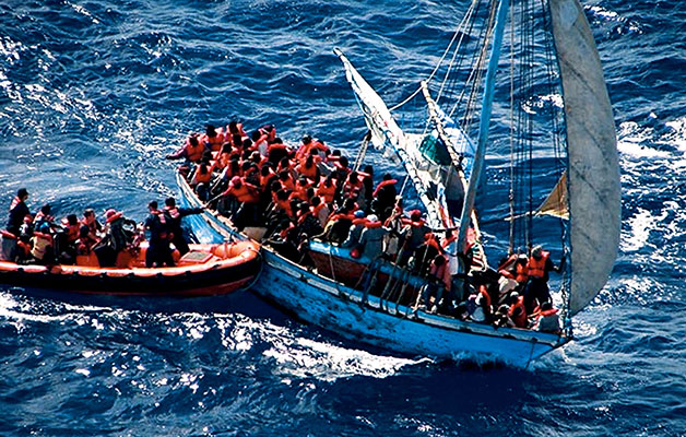 U.S. Coast Guard personnel interdicting a boat load of Haitians attempting to reach the United States.