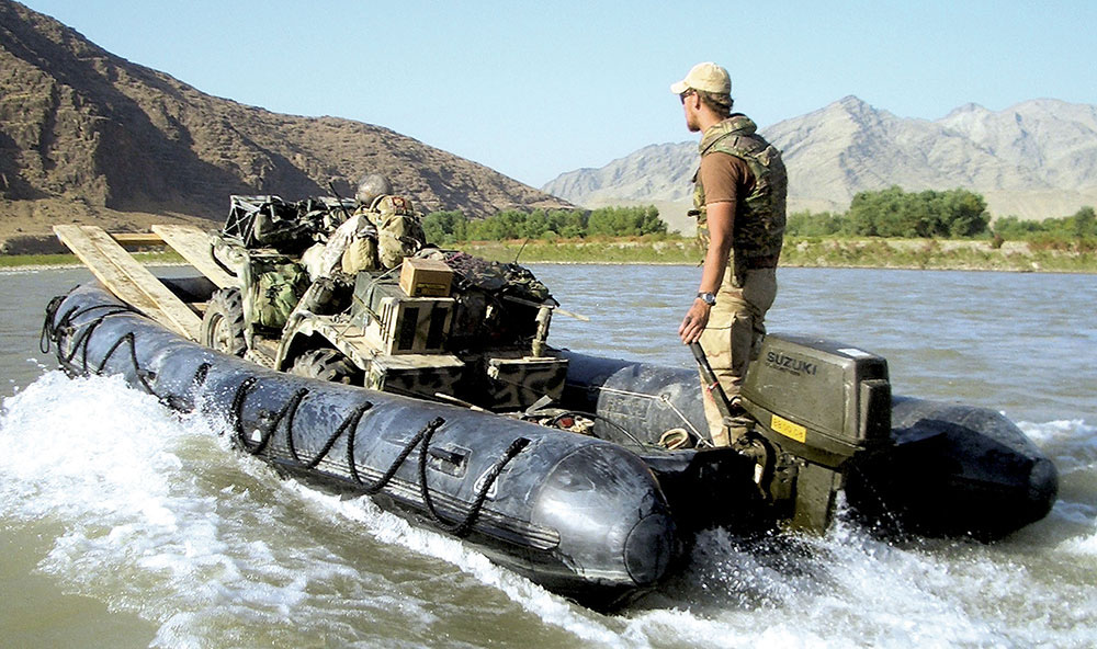 Running up-river with the ATV onboard. The ability to move men and equipment on the river allowed the ODA to invade a Taliban stronghold that was inaccessible by land. The boat operator is a Dutch engineer.
