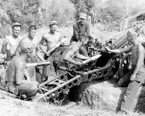 An M1 75 mm pack howitzer with its 613th FAB crew.