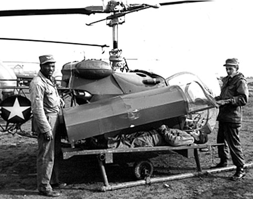 View of the helicopter evacuation pod designed by CPT Sebourn using a U. S. Navy “Stokes” litter, aircraft fabric, and plexiglass. Heater ducts were later added to protect patients during Korean winters.