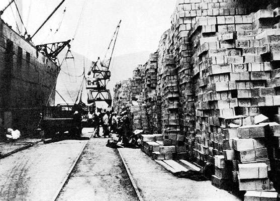 Because the bridges and railroads were destroyed and truck transportation was inadequate, supplies piled up in ports.